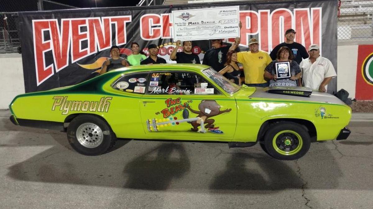 Members of the Central Valley Mopar Drag Pack Team gather around Mark Beavin’s car at the Mopars and Muscle Cars At The Strip event in Las Vegas last month.