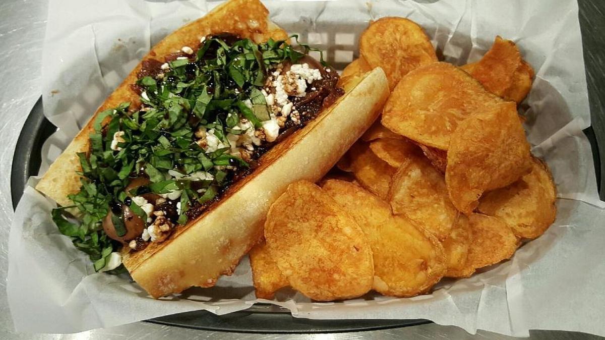 The Napa Dog includes chicken sausage between a grilled baguette with homemade fig-onion jam, crumbled goat cheese, basil and a drizzle of balsamic reduction sauce.