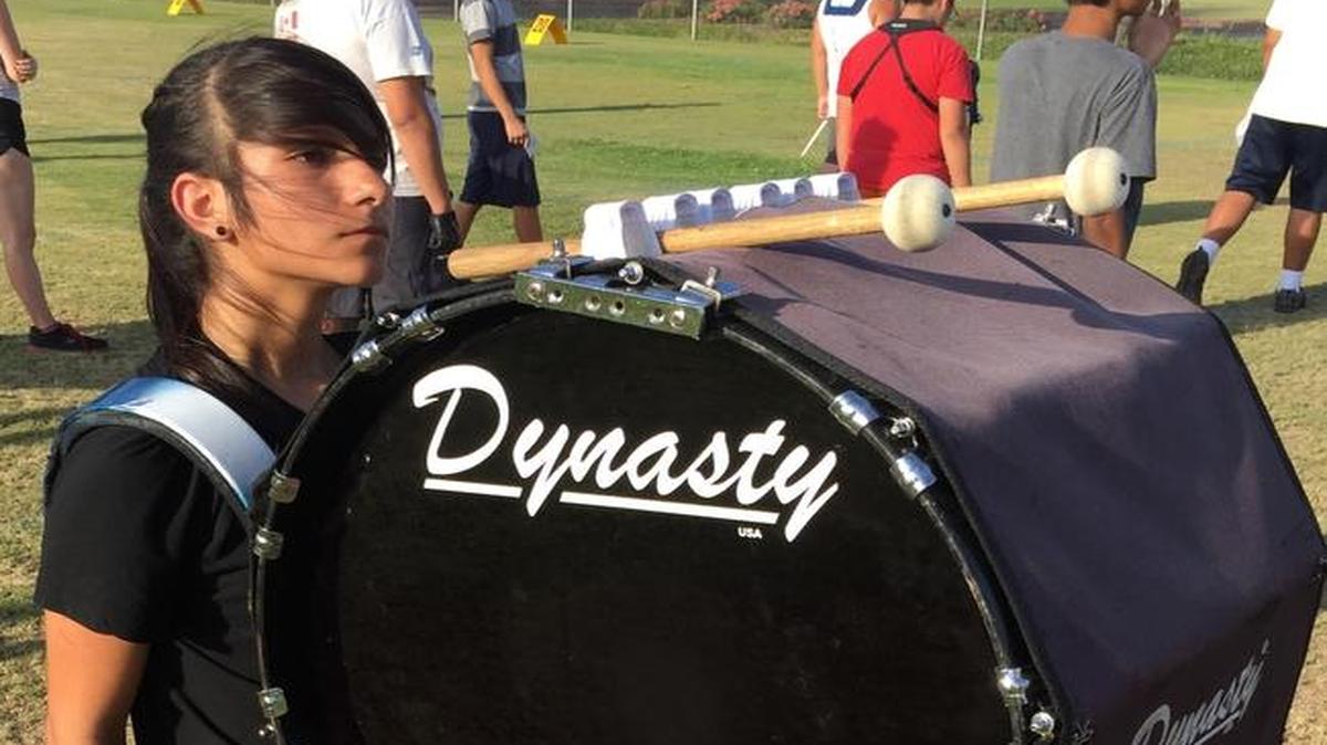 
Kristin Gonzales marches with a bass drum during band practice at Clovis East High School.
