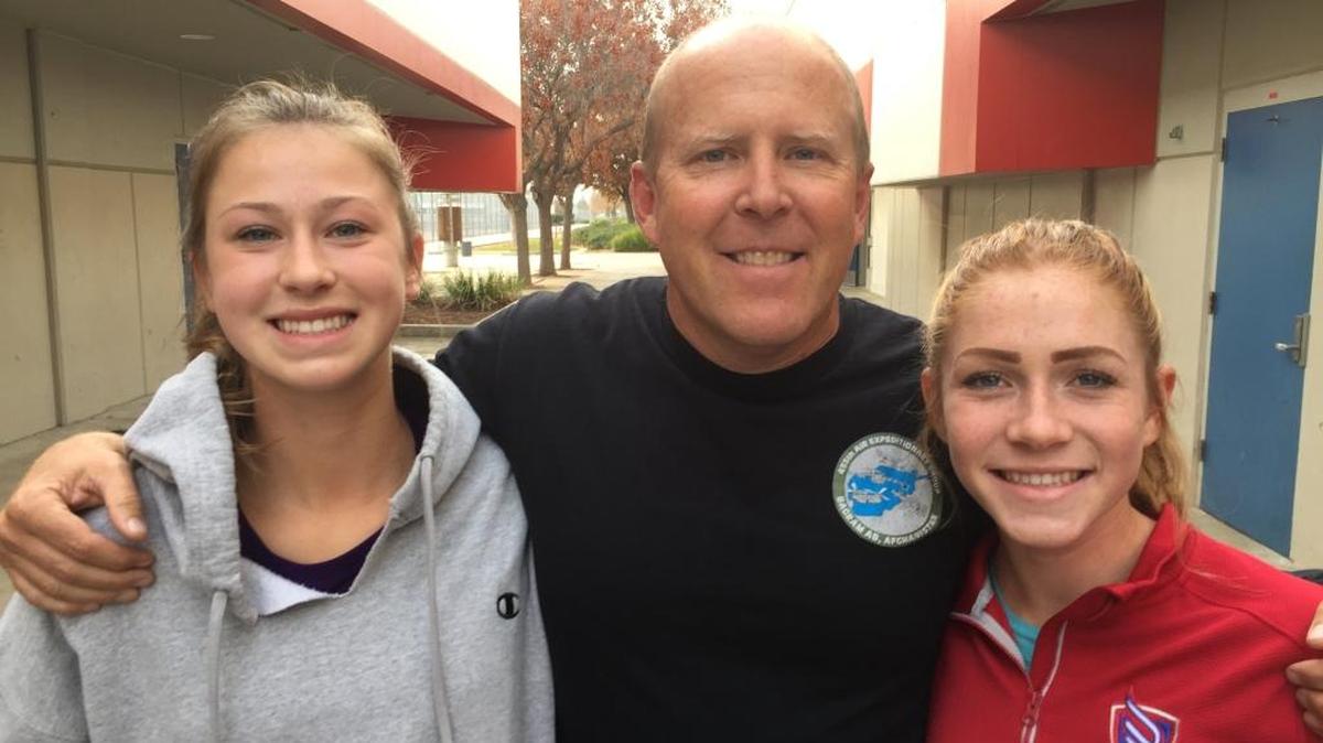 Buchanan High School cross country runners Corie Smith, left, and Meagen Lowe are pictured with Brian Weaver, head coach of the Buchanan cross country program. Smith placed fourth and Lowe placed sixth in Division I at the state cross country championships in November at Woodward Park.