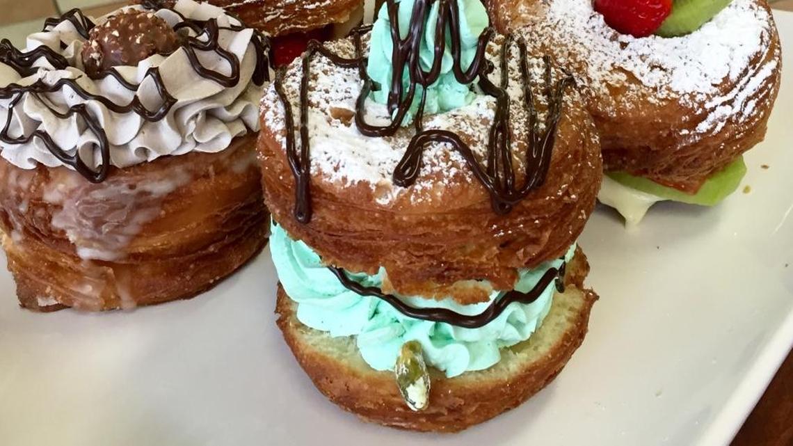 
The gourmet selections at Clovis Donuts include croissant donuts. The one pictured in front features mint whipped cream and chocolate ganache. Other croissant donuts also are pictured.
