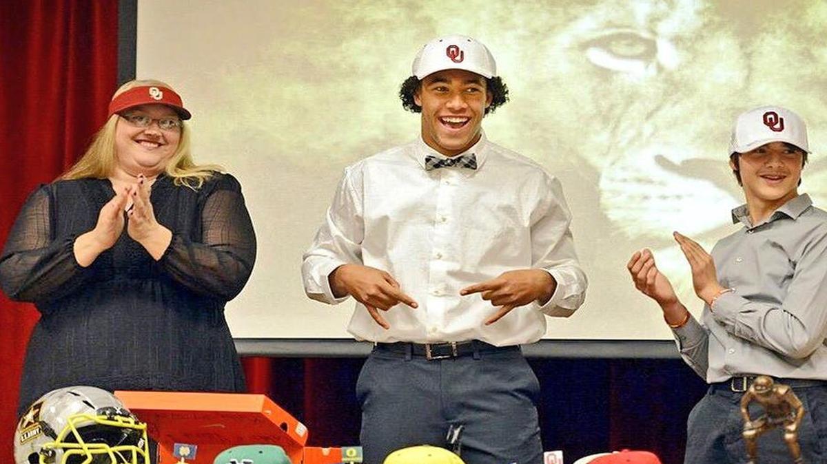 Caleb Kelly, center, celebrates Signing Day with his mother, Valerie Kelly, and brother, Jeremiah.