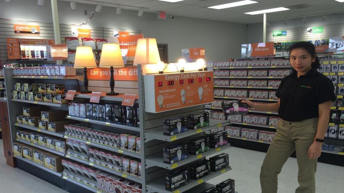 Batteries Plus Bulbs owner Polly Deng picks up one of the store’s many varieties of light bulbs. The business offers CFL, fluorescent, halogen, incandescent, LED and many more bulbs.