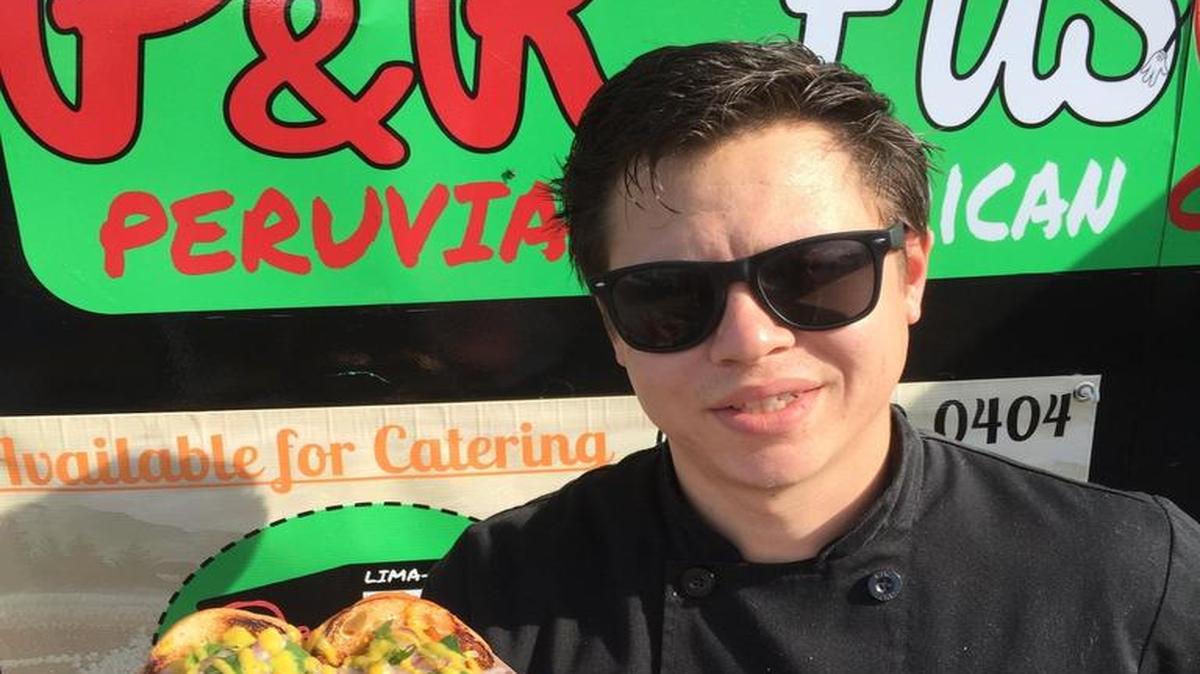 Robert Vieira of P&R Fusion holds a Chicharron Sandwich, one of several Peruvian offerings on P&R’s menu.
