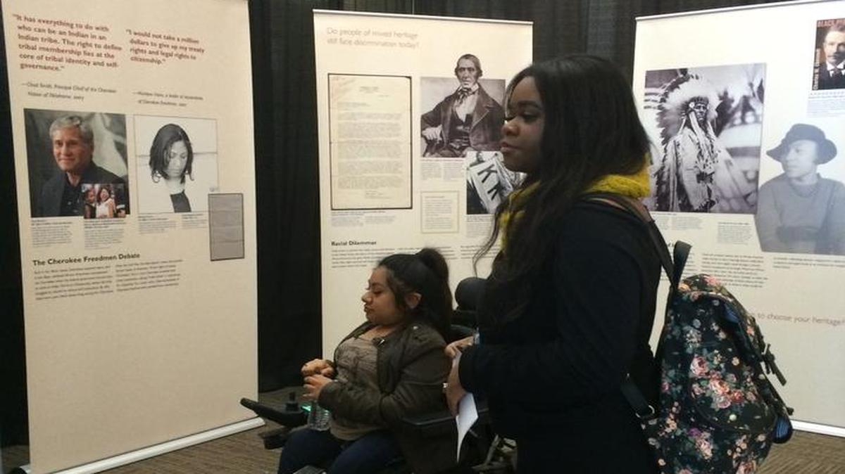 Milca Gutierrez and Kela Lovelace, right, view the Smithsonian traveling exhibit “IndiVisible: African-Native American Lives in the Americas,” which will be in the Clovis Community College computer lab through March 4.