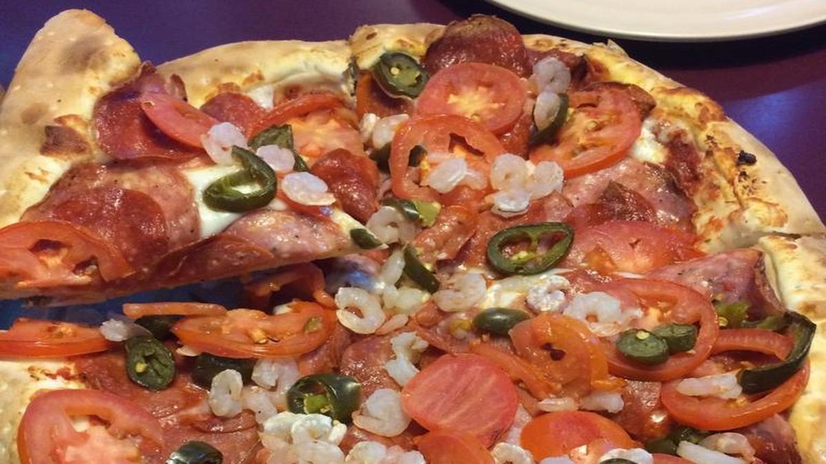 The Volcano pizza at BC’s Pizza and Beer features salami, pepperoni, shrimp, jalapeño and tomato atop marinara sauce and a thick crust.