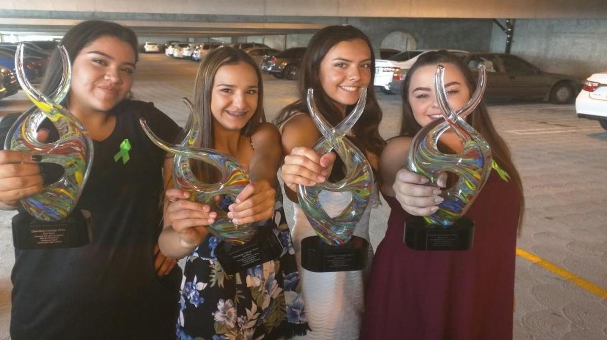 Clovis East students Adryauna Speer, Malia Willison, Caitlin Luster and Maegan Ankenman display the trophies they won in the Directing Change statewide film contest.