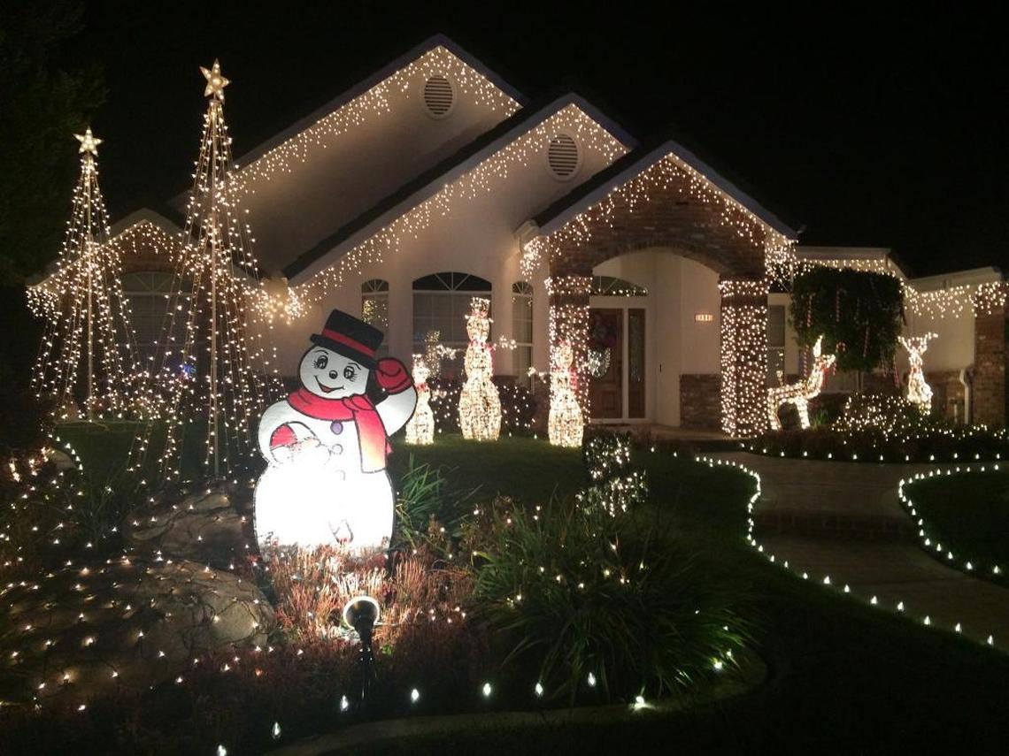 A snowman greets passersby at this home in the Cindy Lane, also known as Candy Cane Lane, neighborhood.