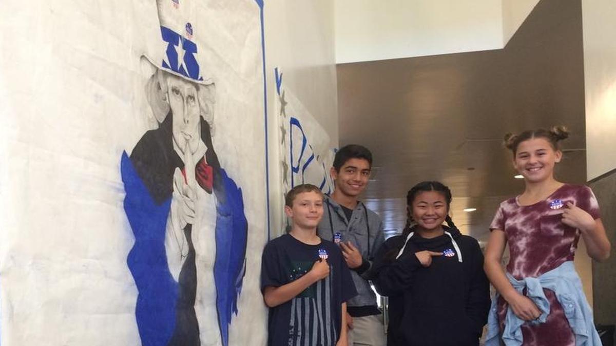 Reyburn Intermediate eighth-graders Ariel O’Hair, Tinkerbell Moua, Evan Yin and Noah Conner voted in a mock election at the Reagan Education Center library.