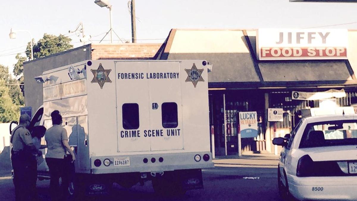 Fresno County sheriff’s investigators are seen at an Easton convenience store Wednesday, June 1. On Tuesday night, a robber was killed in an exchange of gunfire. A second robber was at large.