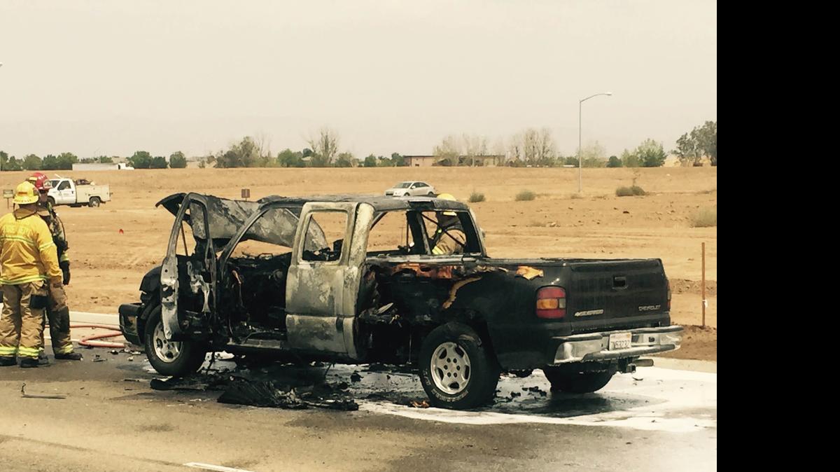 
Firefighters mop up after putting out a burning truck driven by a suspected drunken driver in east-central Fresno on Thursday.

