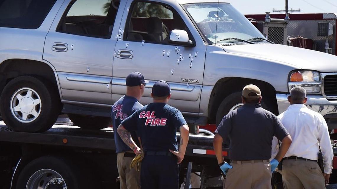 An SUV whose driver led police on a chase is towed away, riddled with bullet holes where it crashed into a gate at Simonian Farms early Sunday morning near Fresno.