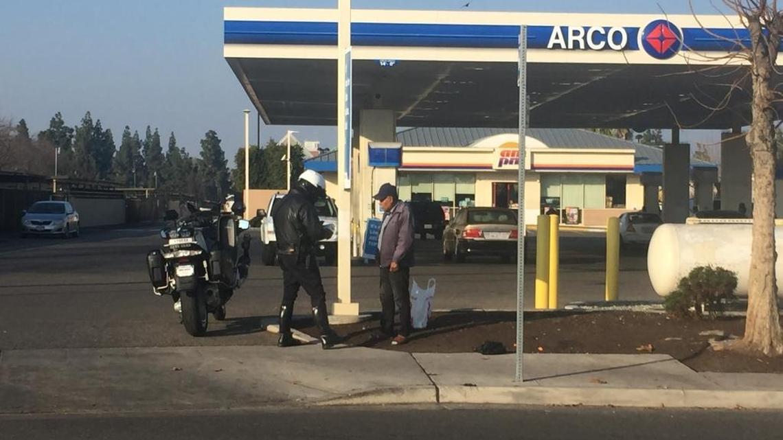 Fresno police officer tickets a pedestrian Friday morning at South First Street and East Tulare Avenue as part of a crackdown on jaywalking.