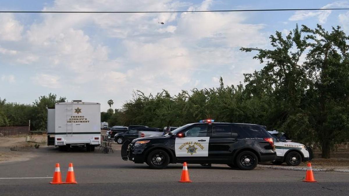 Law enforcement gathers at the scene of a standoff at a home on South Rolinda Avenue, west of Fresno, on Saturday, June 11, 2016.
