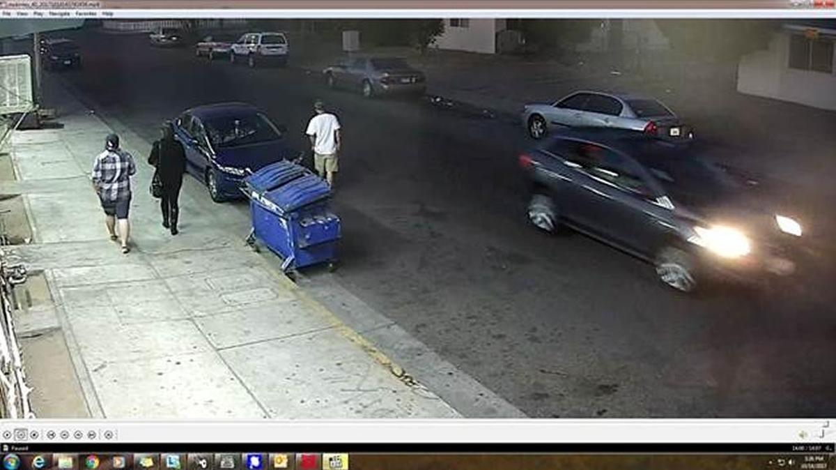 Fresno police are asking the public to help investigators track down this gray SUV, seen to the right on surveillance video the day Rahman Newsome, 21, of Fresno was shot and killed.