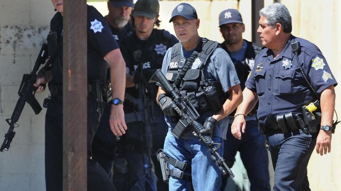 Fresno Police officers search a vacant house, Wednesday June 22, 2016, on Ashlan Avenue west of highway 41 for a suspect possibly involved in a shooting.