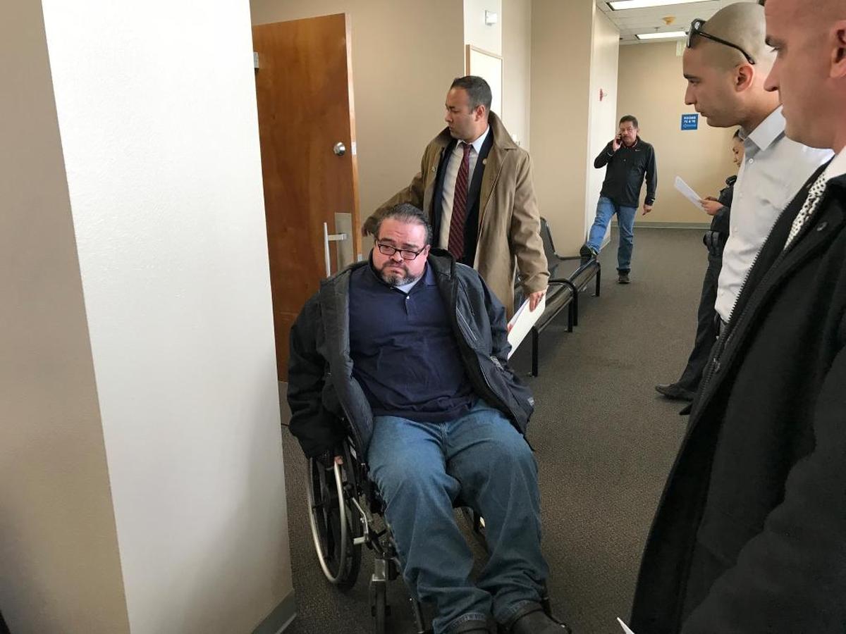 Prosecutor Andrew Janz holds the door to let Francisco Martinez out of a Fresno courtroom. Martinez and Janz attended a hearing for Brandon Carl Sutter, who was sentenced to 32 years to life in prison for shooting Martinez in the back in August 2017, paralyzing him.