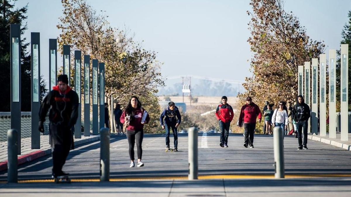Students walk along Scholars Lane on the campus of UC Merced on Nov. 6. Classes resumed that day following an on-campus stabbing which left four people wounded before campus police shot and killed the suspect, 18-year-old Faisal Mohammad, of Santa Clara, on the UC Merced campus two days before.