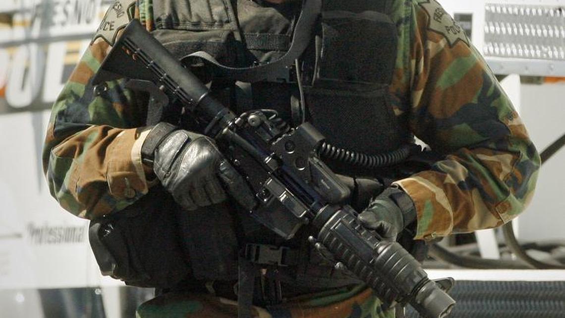 In a file photo, a Fresno police SWAT member gets ready to move in to where a Fresno County sheriff’s deputy and a canine officer were shot by a suspect near a tire shop south of Fresno on July 14, 2009. The suspect was later shot and killed by officers.