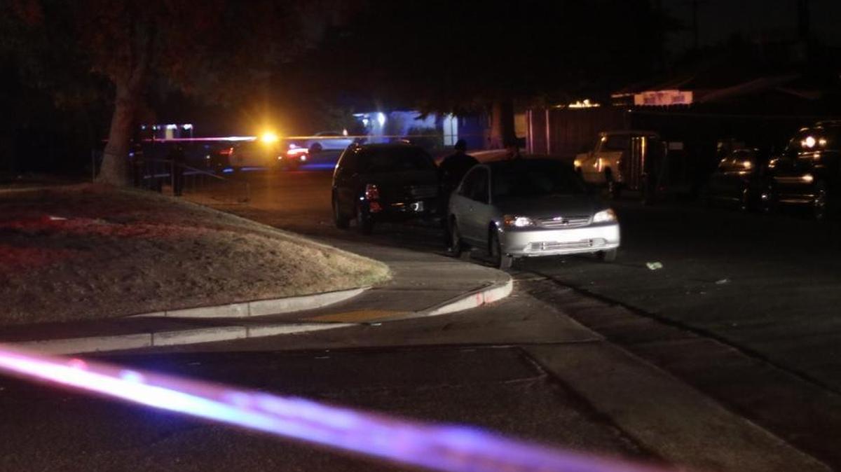 Police at the scene of a shooting Sunday night near Mayfair Drive and Normal Avenue in central Fresno.