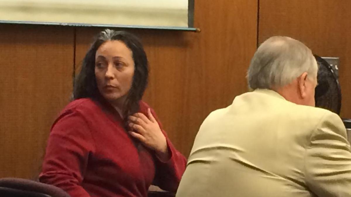 Dawn Singh, left, looks around the courtroom Monday during her Fresno Superior Court trial. She is charged with murder and robbery in the July 2009 slayings of Gary and Sandra De Bartolo of Kerman. Her attorney Eric Green is on the right.