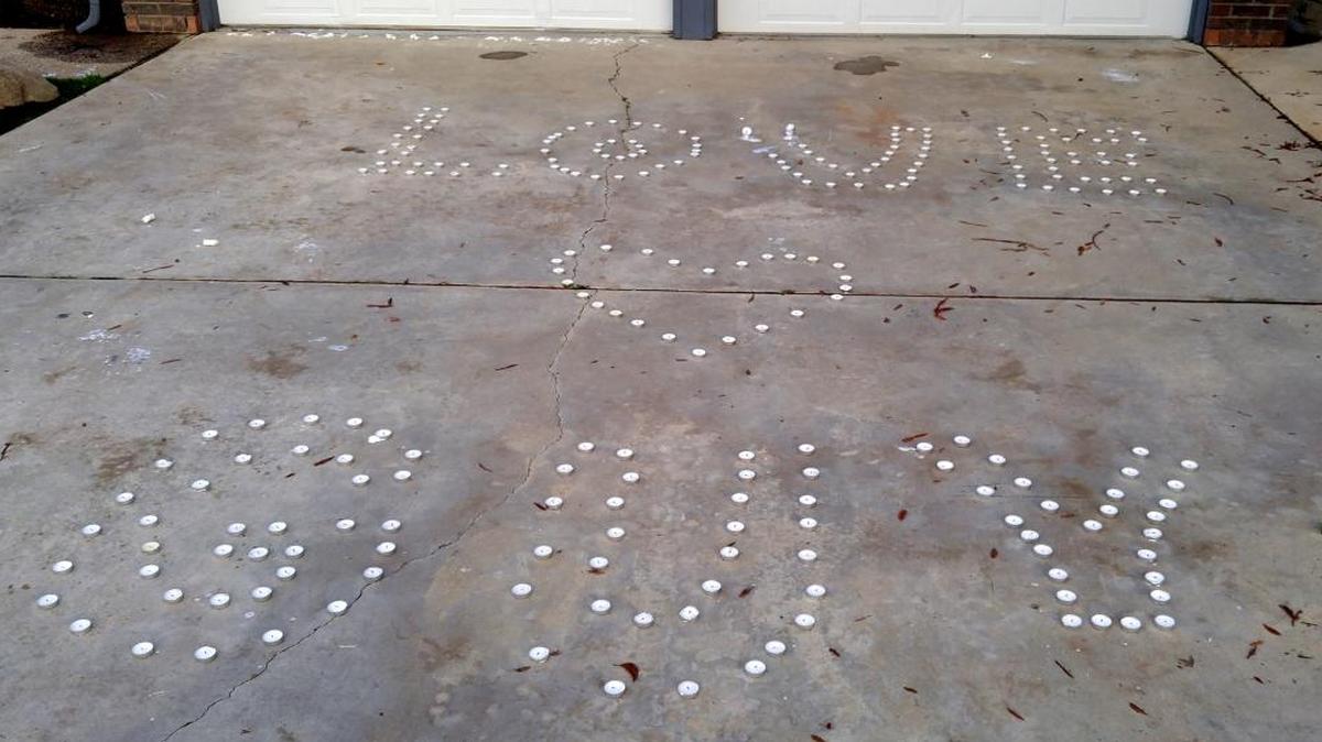 Votive candles spell out “LOVE GUY” on the driveway of a northeast Fresno house Monday, January 11, 2016. Guy Birrenkott, 57, who lives in Friant but owns the home, died early Sunday while trying to shut down a loud party at the house, police said.