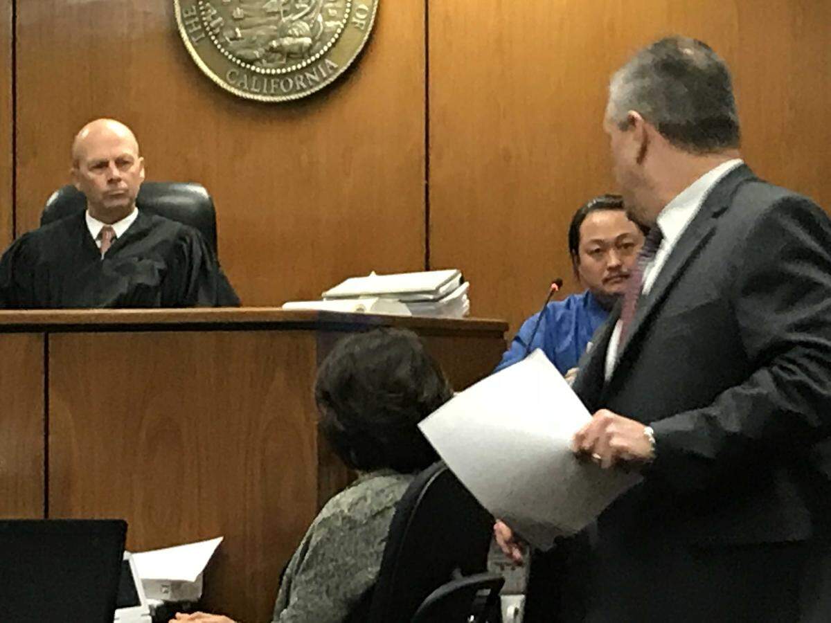 Prosecutor William Lacy shows defendant Thong Vang a letter that Vang wrote to the sheriff's  Internal Affairs unit on Oct. 26, 2016, nearly two months after two correctional officers were shot and critically wounded inside the Fresno County Jail lobby. Also in the photograph is Fresno Superior Court Judge Timothy Kams.