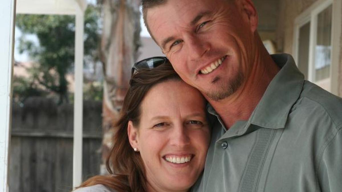 Veronica Brouwer and her husband Matt Brouwer embrace in a family photo.