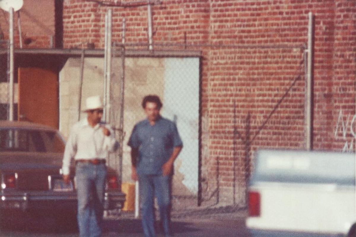 Fresno police officer Pete Santellano and DEA agent “Kiki” Camarena walk out of La Flor de Mexico in Fresno’s Chinatown after making a heroin buy in this 1974 photo taken from an undercover surveillance van.