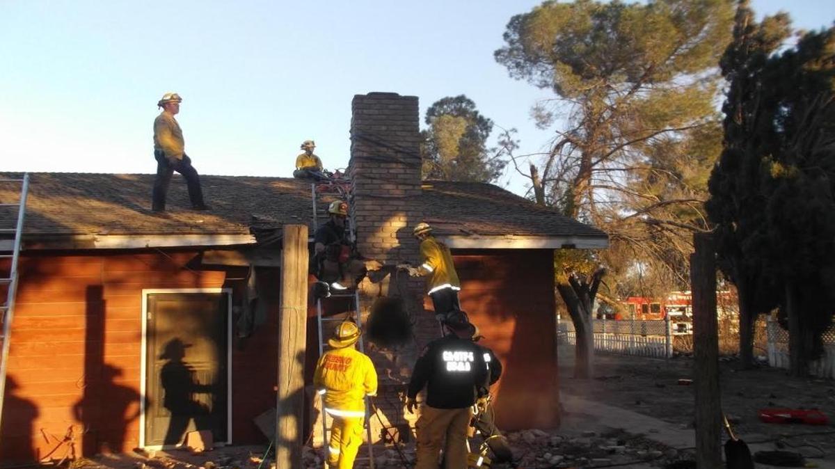 Fresno County firefighters work to free a man from a chimney. The man, suspected to be a home burglar, had gotten stuck. He was later found dead in the chimney.