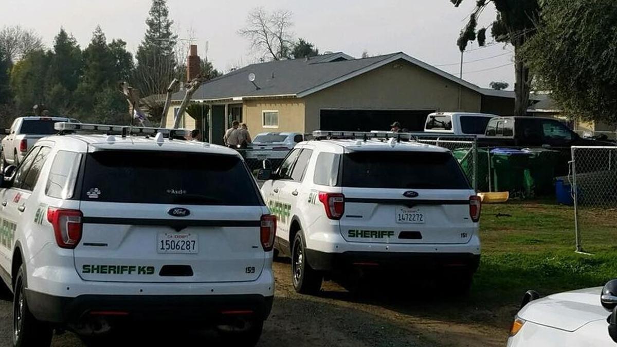 Tulare County Sheriff’s Department officials converge on the site of an illegal cockfight Sunday afternoon in Lindsay.