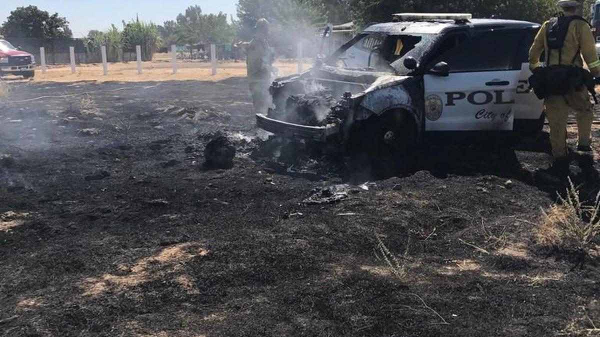Firefighters put out flames after a Madera police SUV set grass on fire, destroying the vehicle after a pursit.