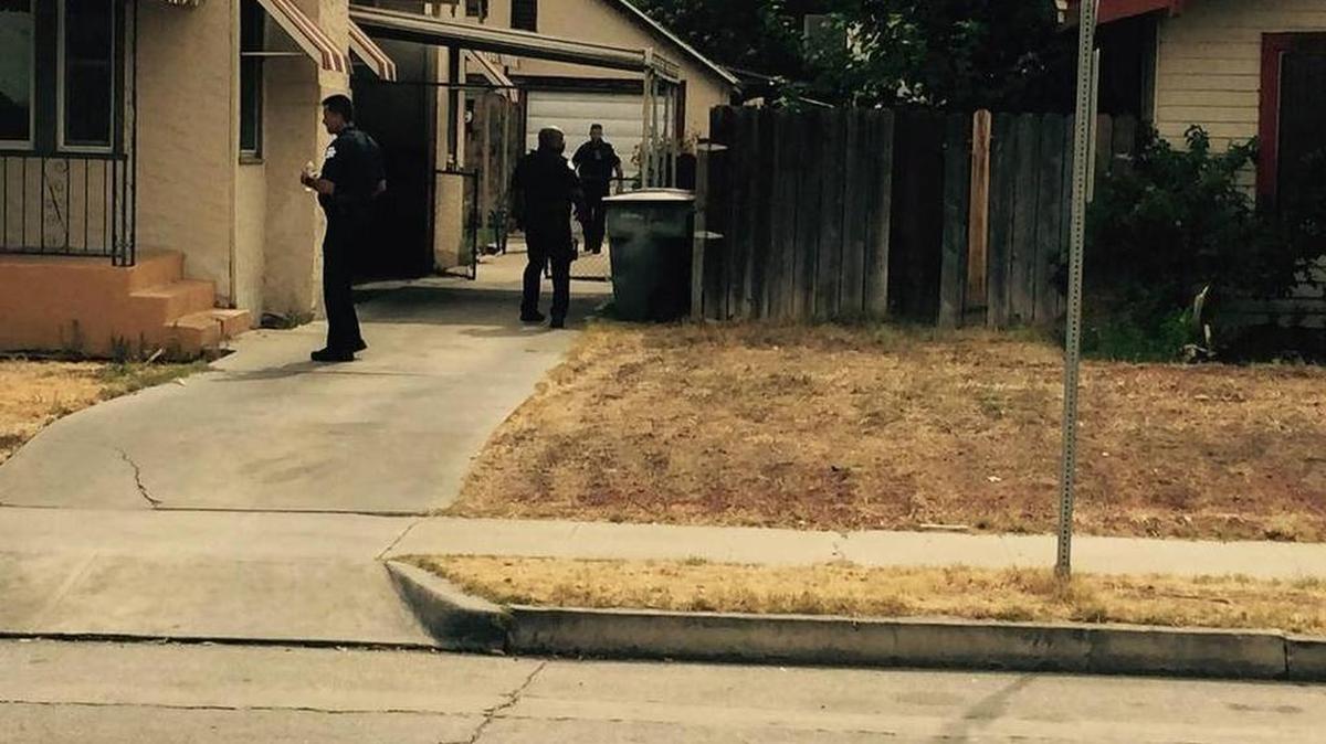 
Police surround a home in Fresno’s Tower District on Thursday after a burglar broke in, frightening two children.
