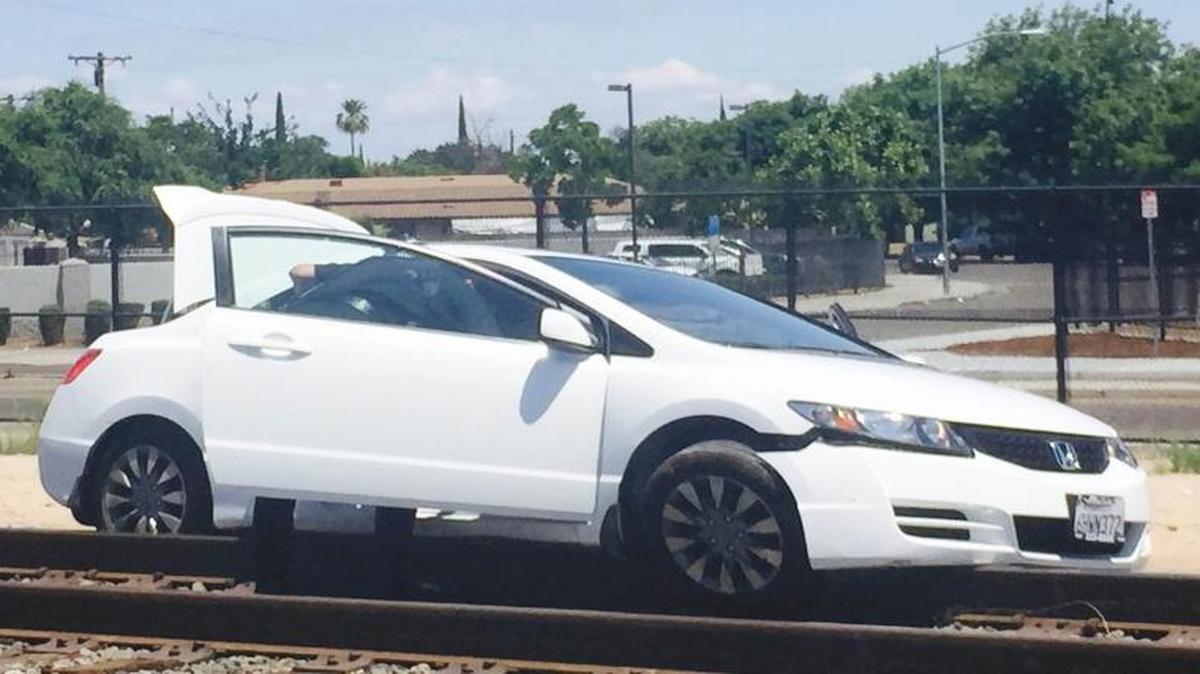 A car reportedly became stuck on railroad tracks after a shooting incident near McKinley and Golden State.