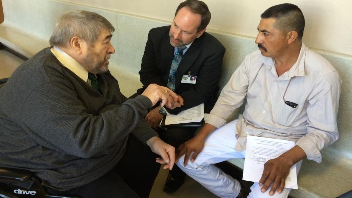 Defense attorney Arthur Collins, left, talks with his client, Agustin Martinez Mendoza, right, who was sentenced Friday to probation and a work program in connection with a crash near Orange Cove in January 2015 that left four farmworkers dead. Mendoza was driving a van carrying eight passengers. Courtroom interpreter Steven Buller, middle, is translating for Mendoza.