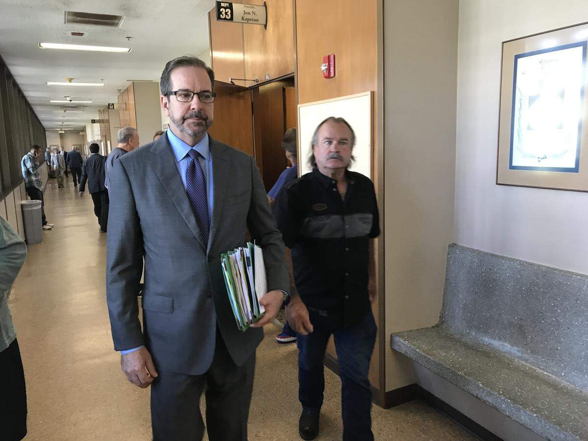 Patrick Wayne Holmes, 63, of Clovis, right, leaves a Fresno courtroom with attorney Jeff Hammerschmidt on Tuesday, June 12, 2018, after being sentenced to five years in prison for being drunk and riding his motorcycle into three bicyclists on Auberry Road northeast of Fresno in July 25 last year. As part of a plea agreement, Holmes does not have to surrender until July 3, 2018.