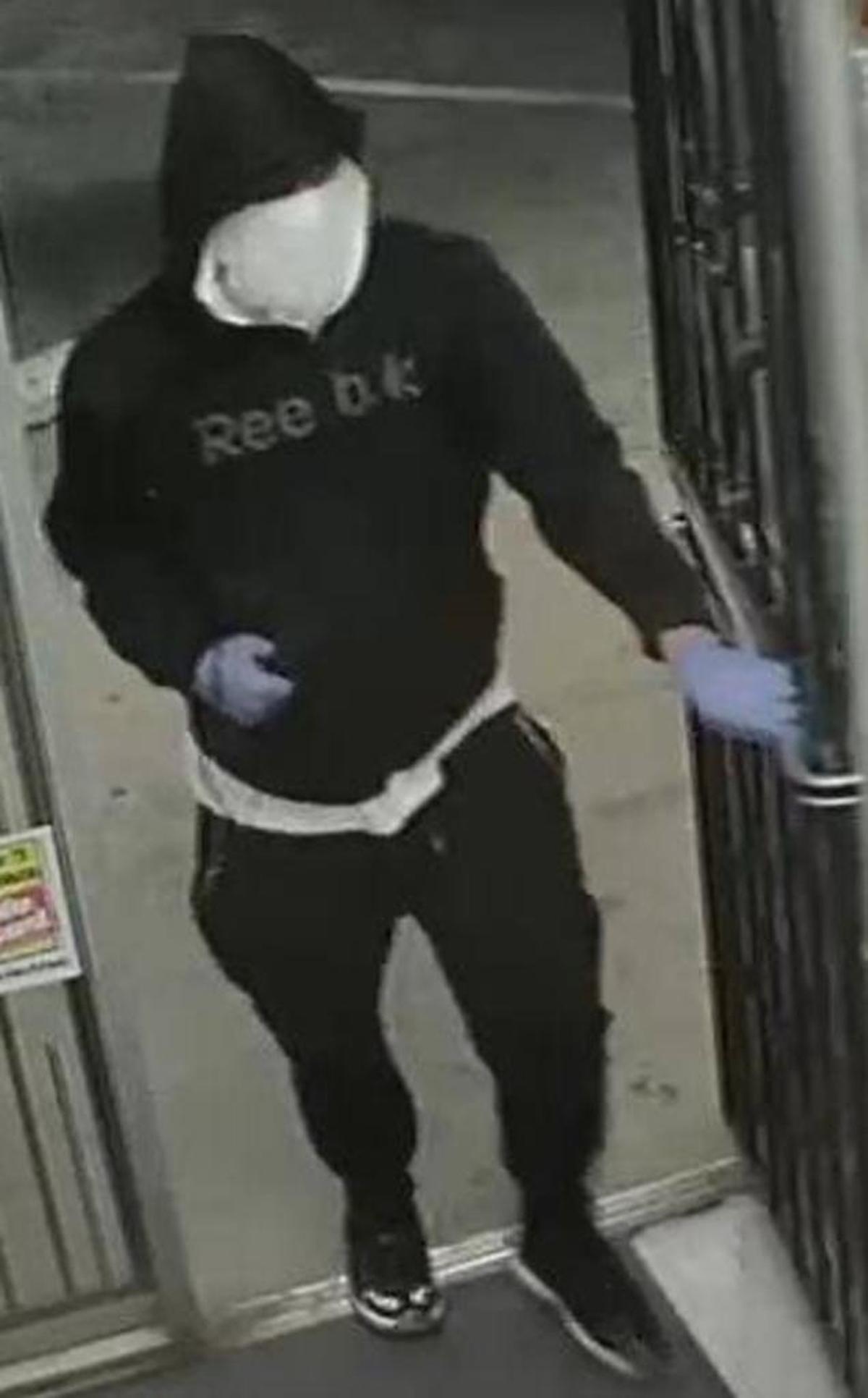 An image from security video shows one of the two men who robbed a Madera County gas station and mini-mart Monday, Nov. 13, 2017. The store clerk was shot and killed during the robbery.