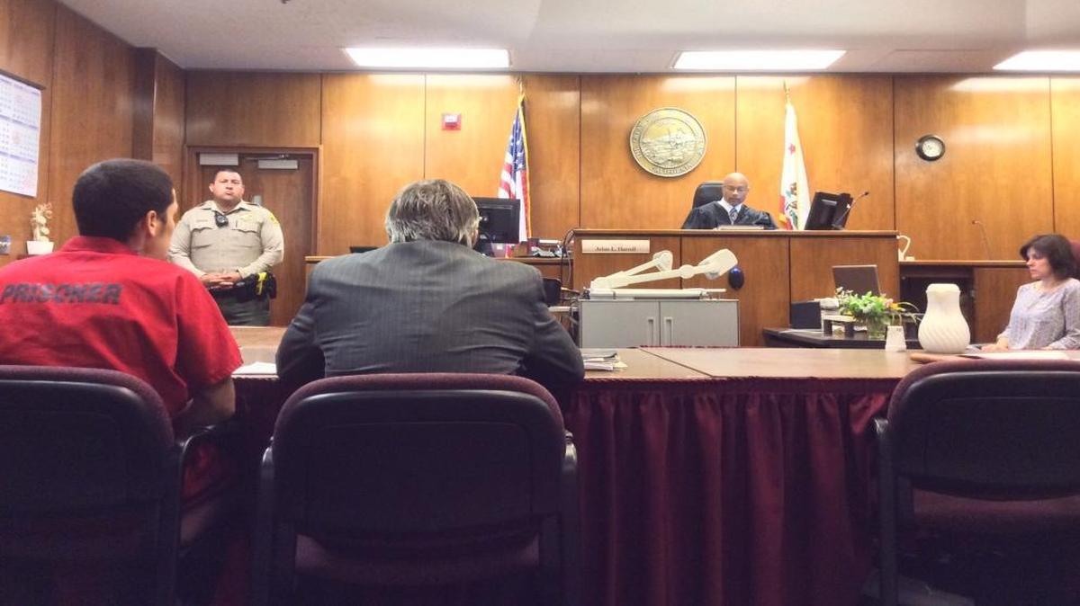 Christian Joel Medina, 20, left, sits with his defense attorney during a sentencing hearing in Fresno County Superior Court on Thursday. Judge Arlan L. Harrell sentenced Medina to 16 years to life in prison for stabbing Leonel Ortega, 27, to death in February 2013.