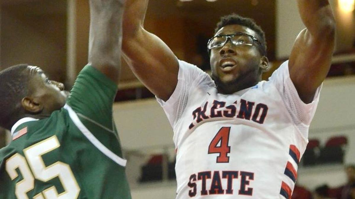 Fresno State’s Karachi Edo jams against Cal Poly's Joel Awich in a December 2014 game. The Fresno County District Attorney’s Office announced Tuesday it would not press charges of domestic violence against Edo for an incident involving a girlfriend.