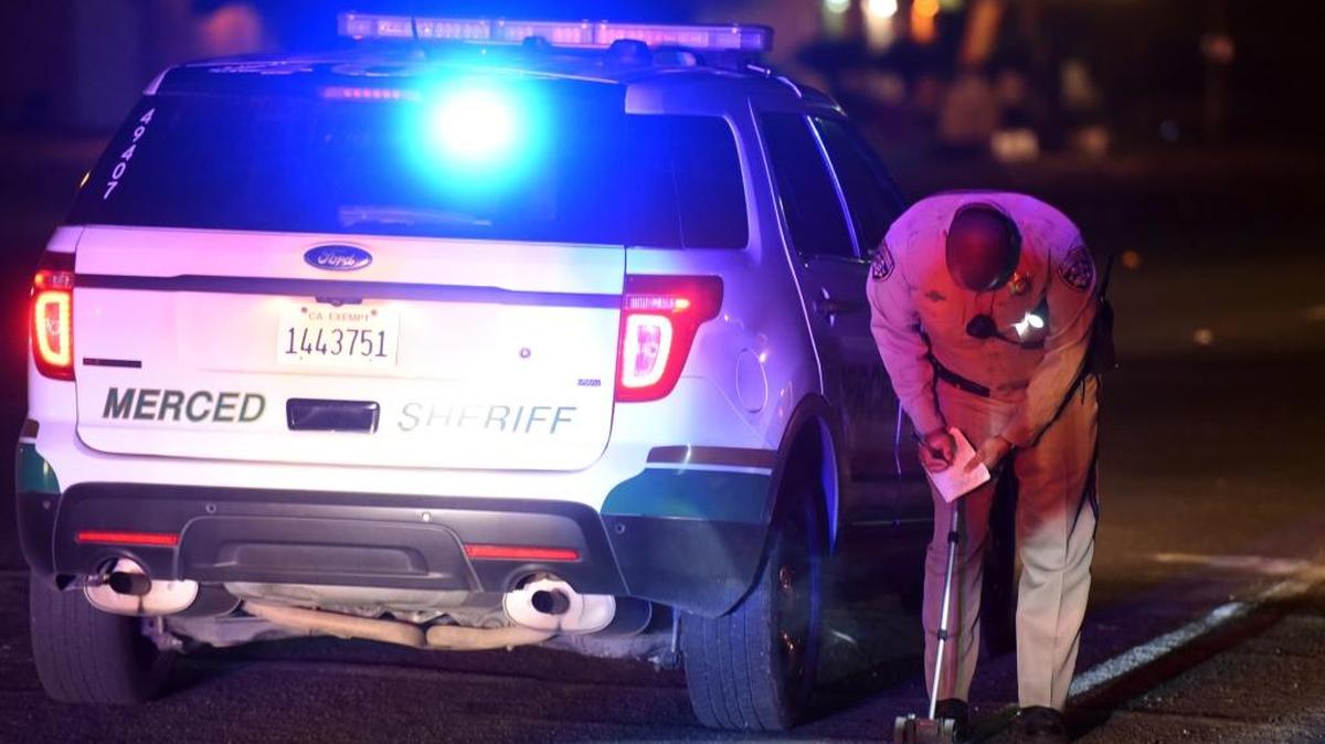 A California Highway Patrol officer takes measurements on Winton Way a few feet away from where a man died south of Santa Fe Drive when a truck struck him on Thursday, Dec. 1, 2016. The truck driver fled the scene.