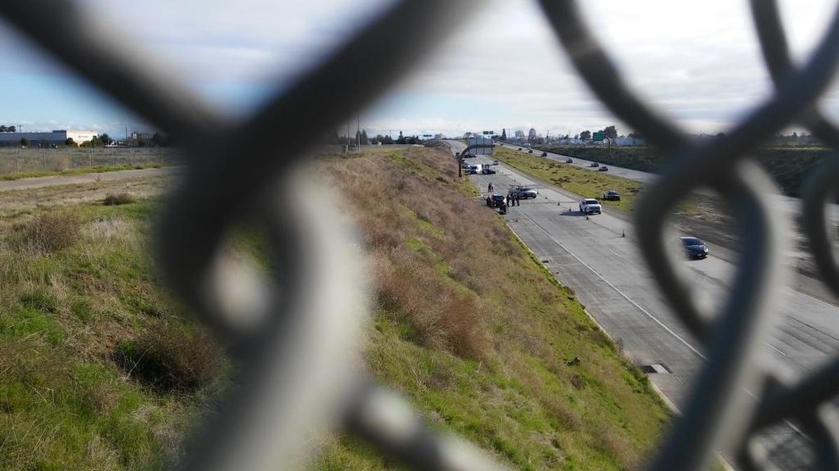 Fresno police and crime scene investigators on the westbound lanes of Highway 180 on Saturday, Dec. 24, 2016 investigate the body of a man who was dead with a gunshot wound.