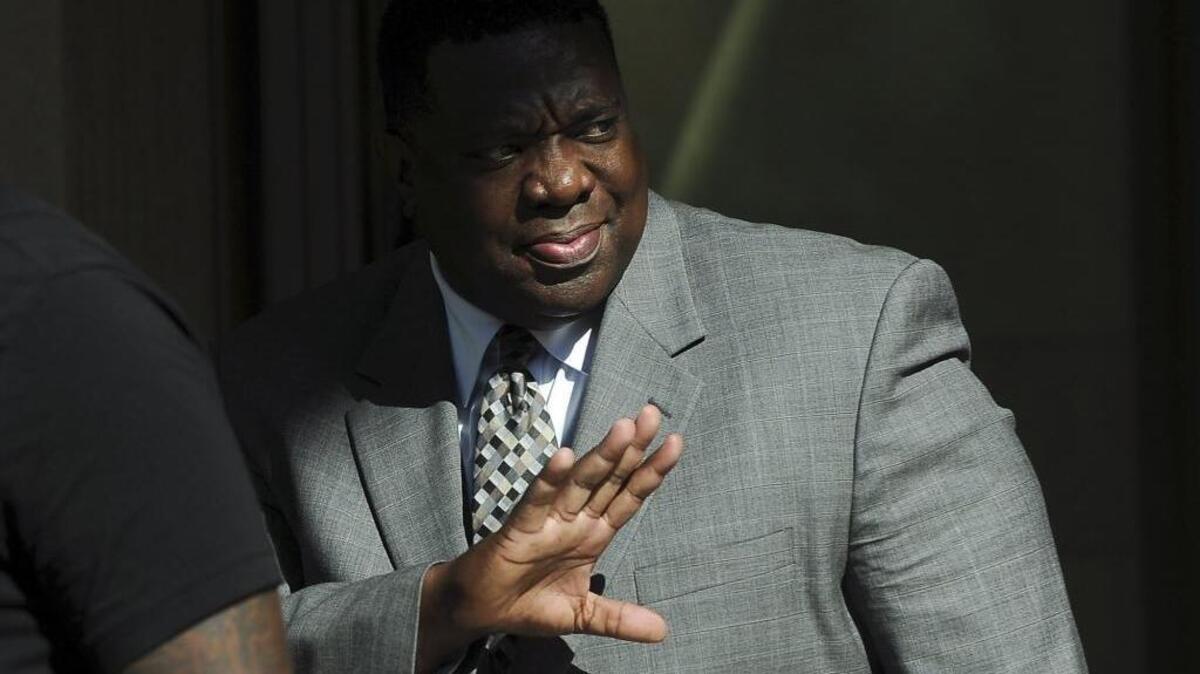 Keith Foster waves as he exits the federal courthouse Wednesday in Fresno.