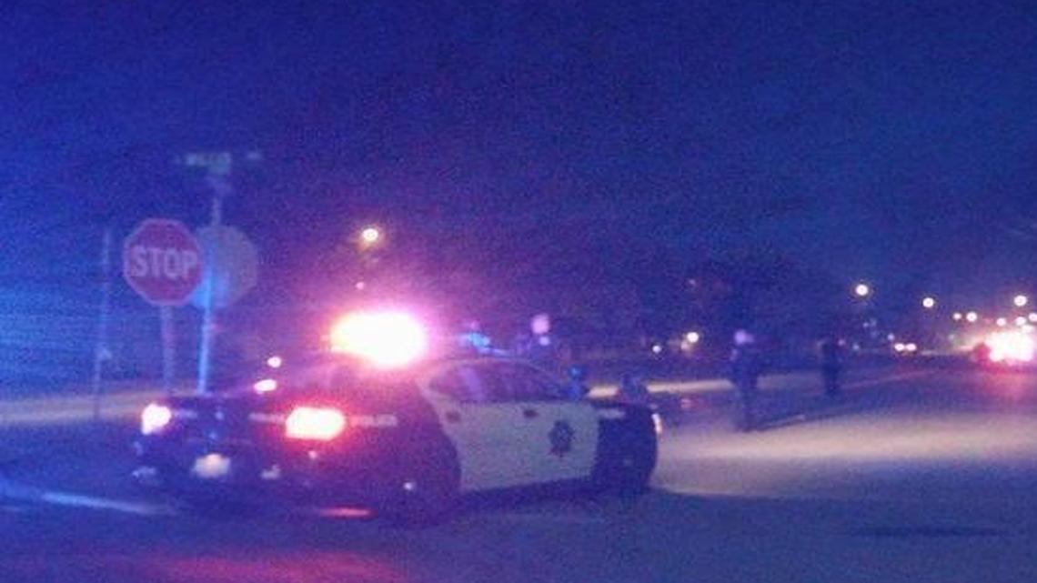 Fresno police vehicles surround two suspects in a shooting in central Fresno Saturday night.