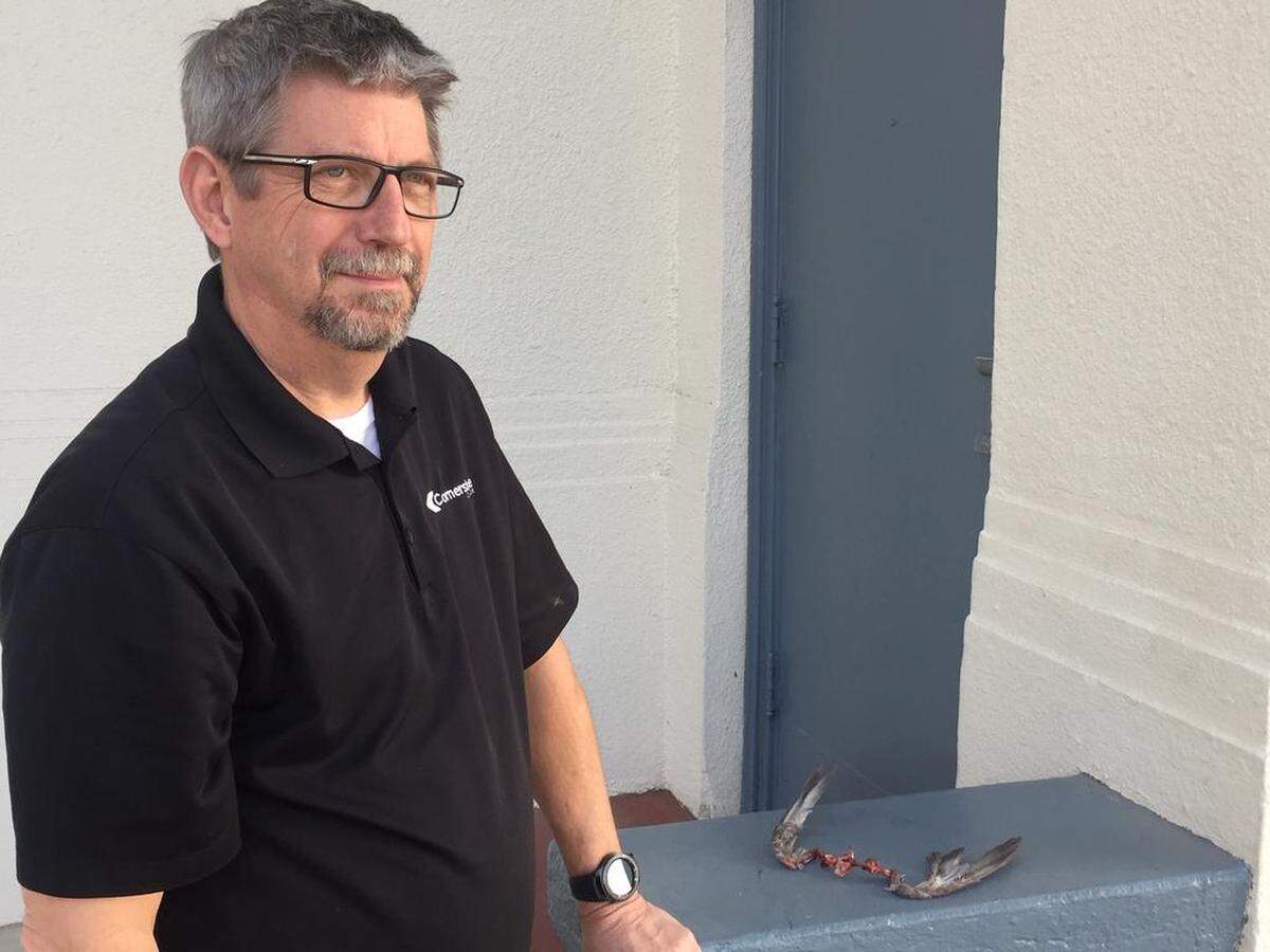 Pastor Jim Franklin at Cornerstone Church stands next to occult “flying spirit wings” left next to the side entrance of the church by an unknown person.