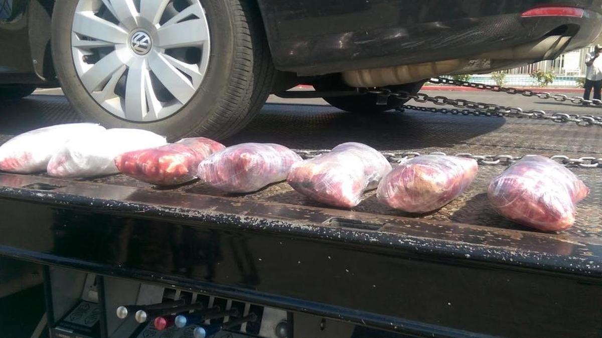 Packages of methamphetamine, bundled in red plastic wrap and worth a total of $75,000, are shown by authorities. Police arrested a man in a Denny’s restaurant parking lot in an undercover sting.