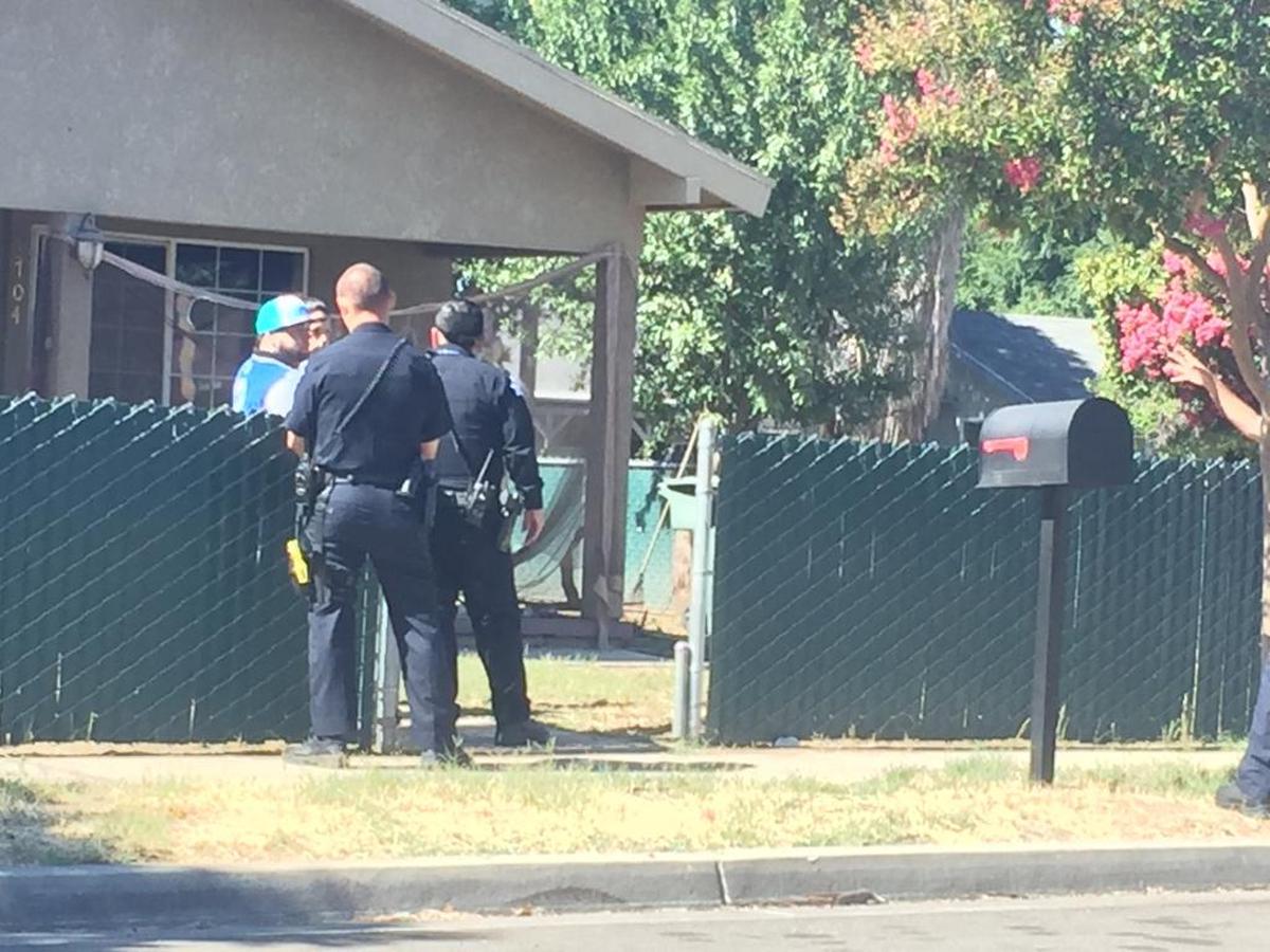 Fresno police officers Wednesday talk to a man who was inside a house with two women on El Monte Way near Orange Avenue in southeast Fresno.