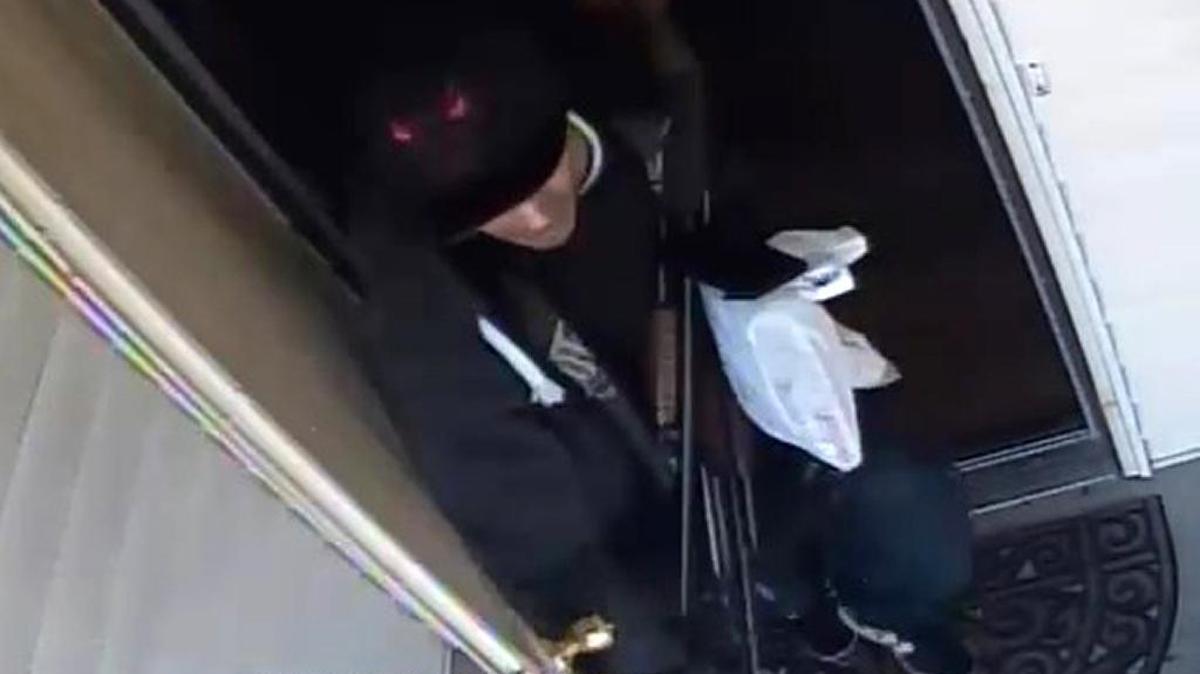 A security camera image shows a suspect stealing guns from a Fresno home Feb. 26. Two people have been taken into custody and a third is sought, police said.