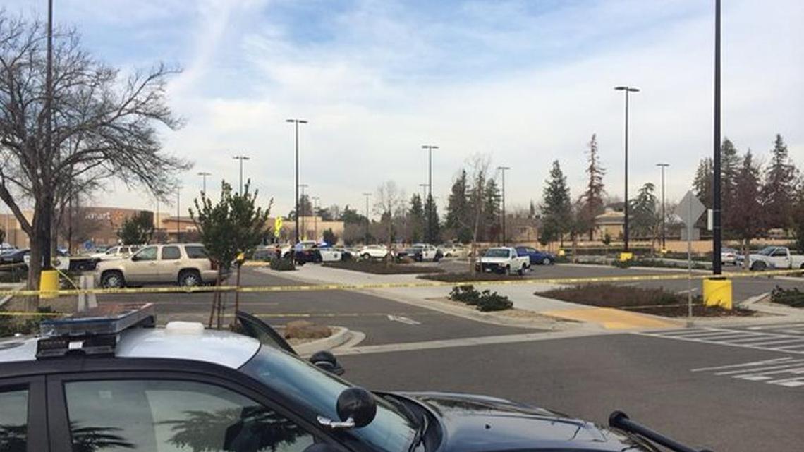 Yellow crime tape marks the scene where a man was shot Wednesday afternoon in the parking lot of the Walmart on Kings Canyon Road in Fresno.