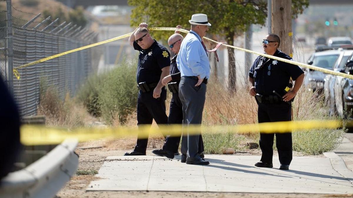 Fresno police officers and detectives arrive on scene of a dead body discovered in the canal near Highway 180 and Marks Avenue in west Fresno on Tuesday, Oct. 10, 2017.