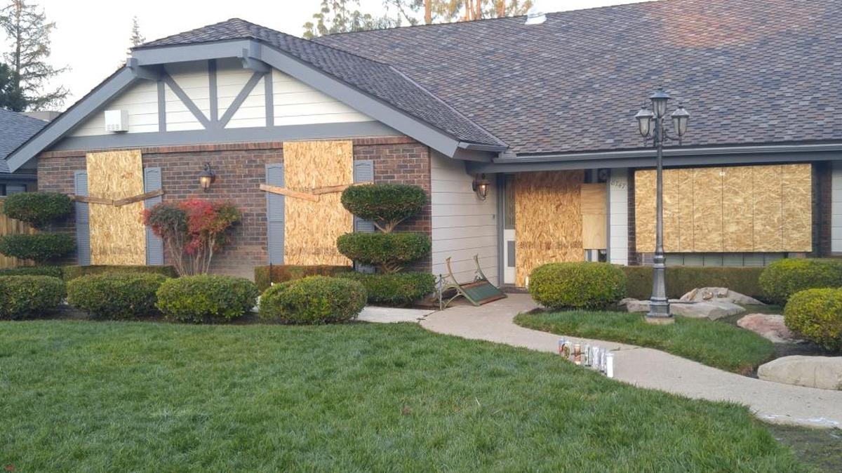 Windows are boarded up Monday, Jan. 11, 2016, at the northeast Fresno house where a man identified by police as the homeowner, 57-year-old Guy Birrenkott, died. Birrenkott was reportedly trying to shut down a rowdy party when violence broke out. His cause of death is unknown.
